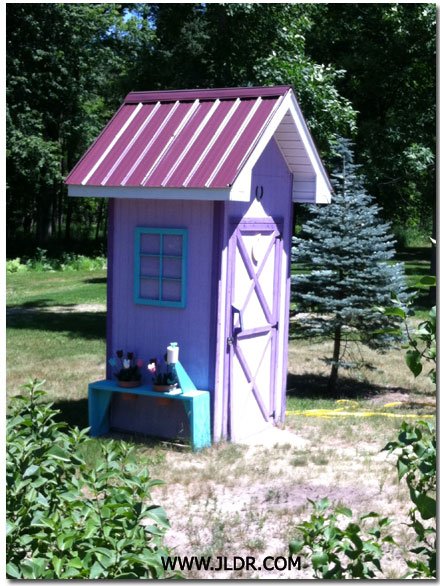 Really Nice Outhouse with a Metal Roof
