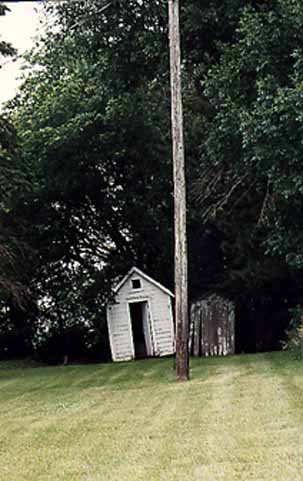 A Telephone Pole View of the Rosendale Church Outhouse