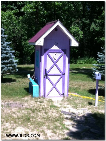 Really Nice Outhouse with a Metal Roof