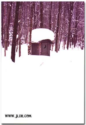 Michigan winter outhouse in the distance