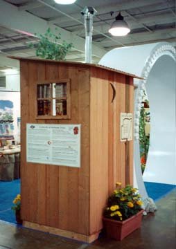 Back View of the Outhouse with a Huge Sewage Pipe in the Background